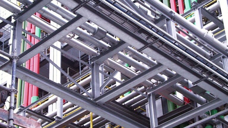 Pipework in a chemical factory, the industrial scale peptide synthesis has grown into