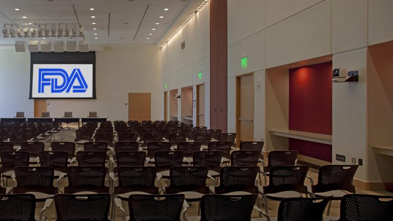 Auditorium at the United States Food and Drug Administration with the FDA logo on screen