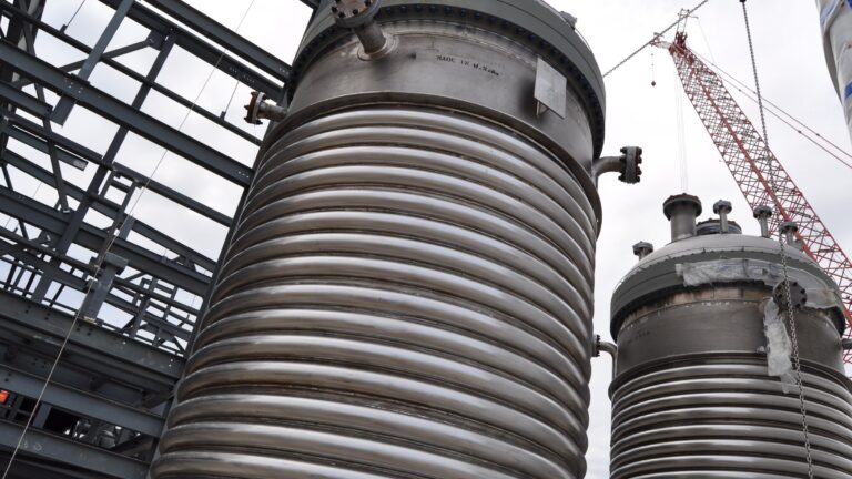 Large stainless steel jacketed reactor vessels at an industrial chemical plant