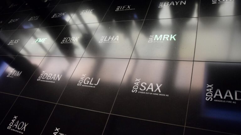 Stock exchange floor marked with listed company tickers, including pharmaceutical groups